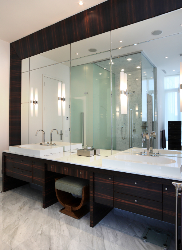 Twin surface mounted sinks, bevelled and etched mirrors with exotic hardwoods